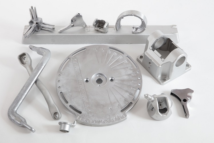 index plate with engraved markings, mechanical housings, levers, brackets, and other precision-machined pieces used in machinery or automotive assemblie