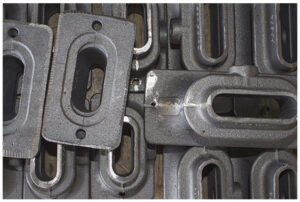 Precision rectangular metal castings with machined slots and mounting holes for automotive and industrial applications
