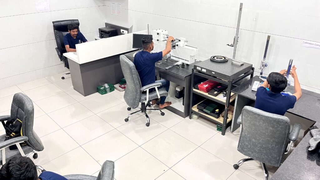 Engineer operating CMM to verify tolerances of CNC machined part